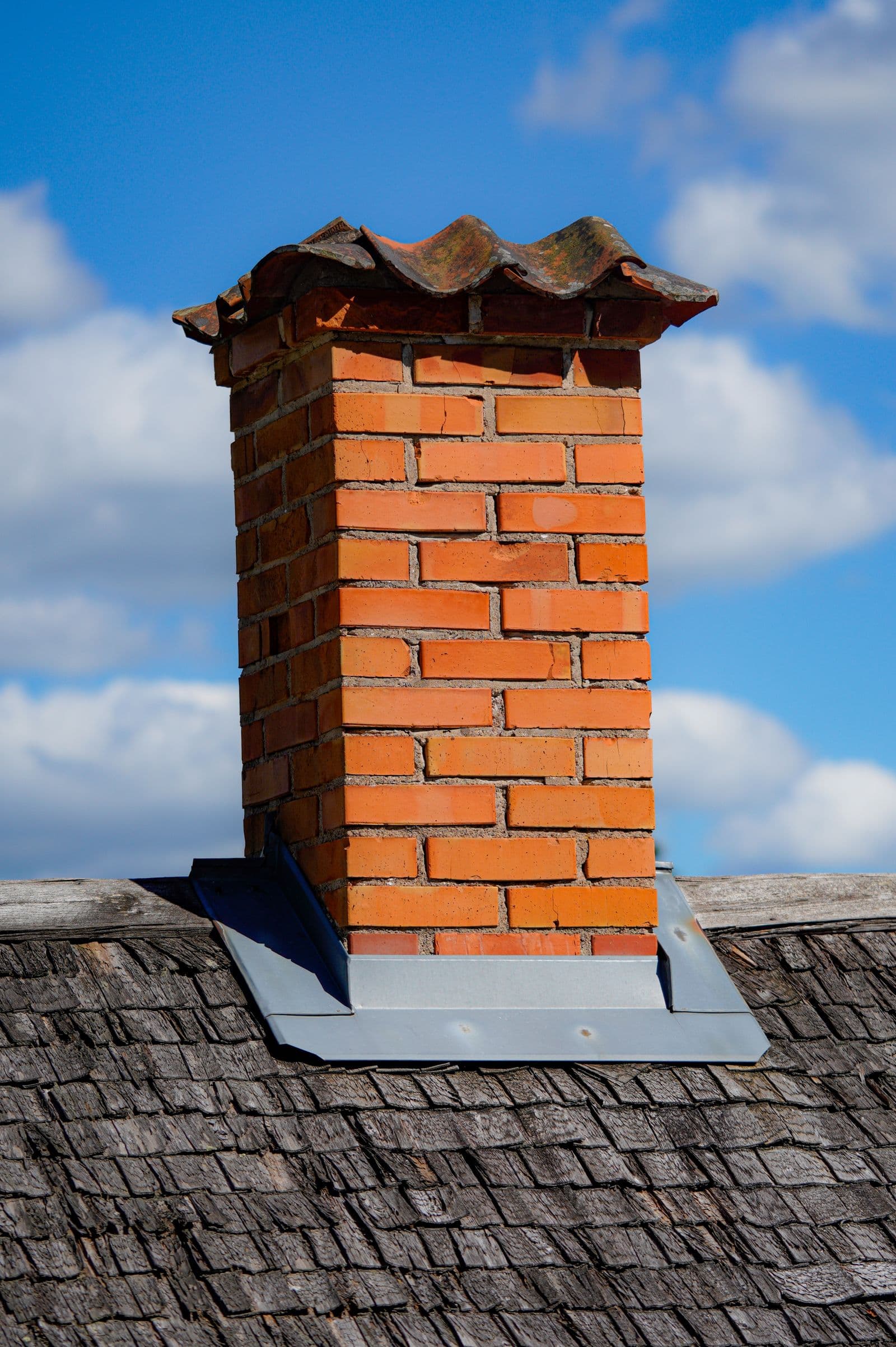 Rebuilt brick chimney on a shingle roof