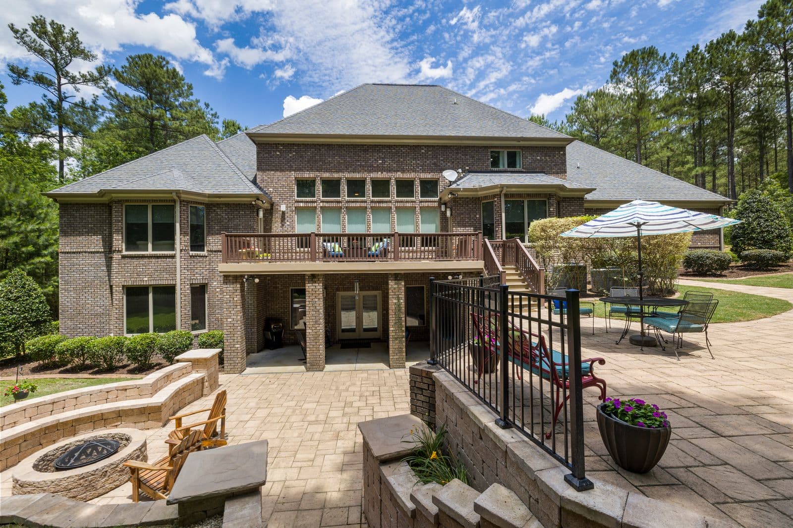 Paver patio with a stone fire pit and outdoor seating